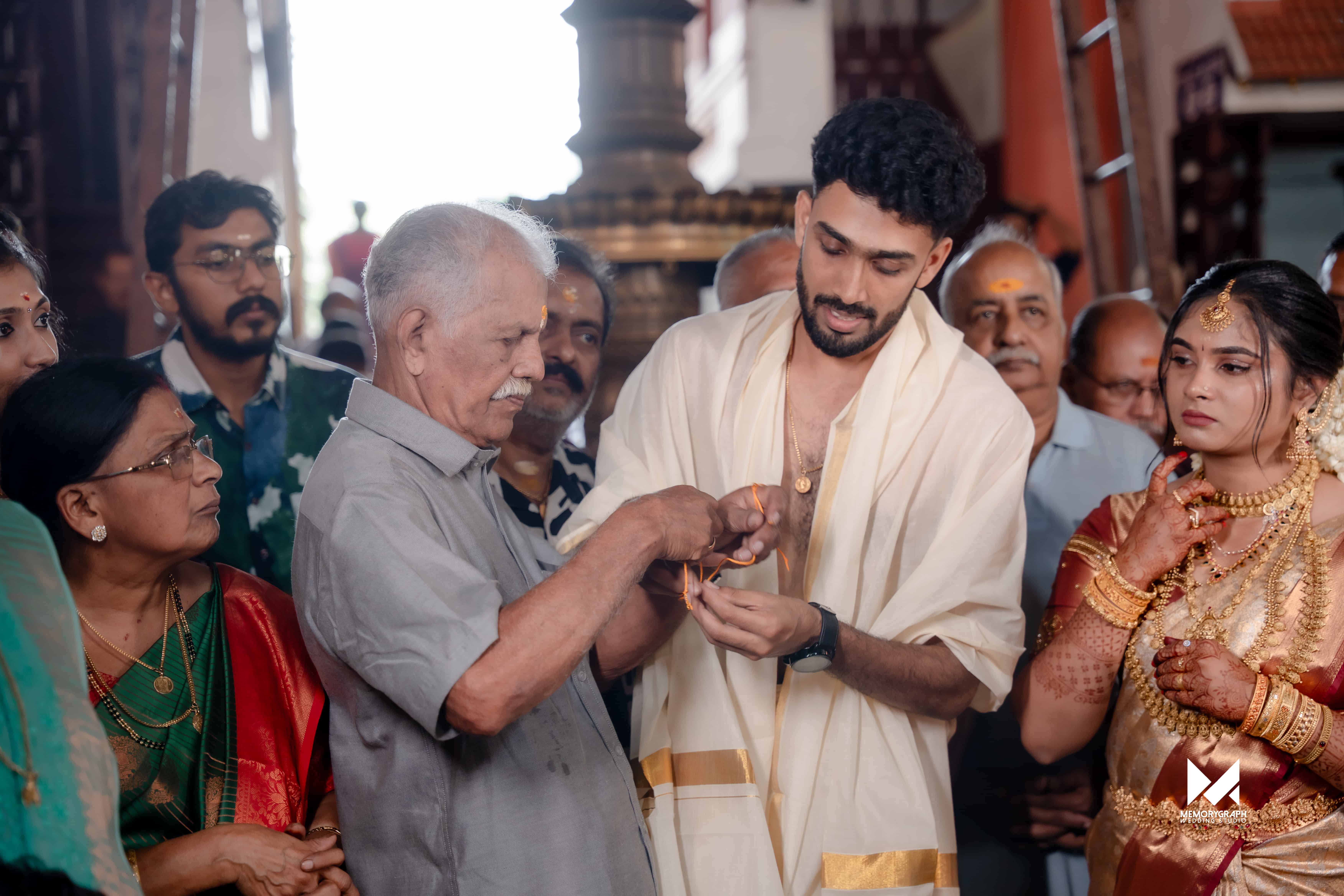 Traditional Kerala temple wedding ritual captured in warm interior light
